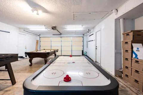 Converted garage game room with air hockey table, billiards table and foosball at Quail Creek Manor, Oklahoma City