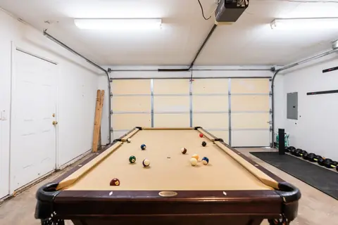 Garage game room with regulation pool table at Quail Creek Manor
